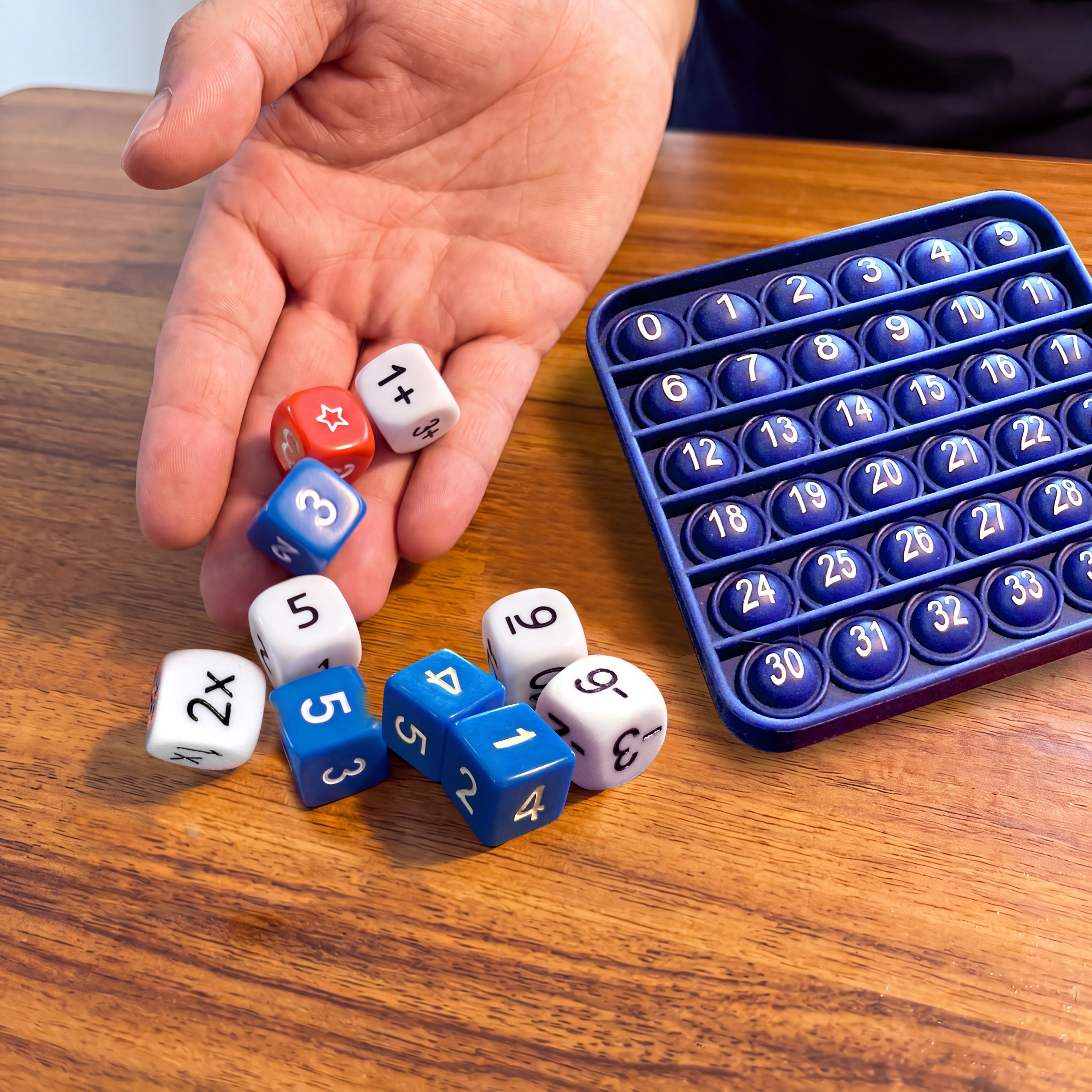 ArithMatrix addition game with custom dice and numbered silicone pop mat